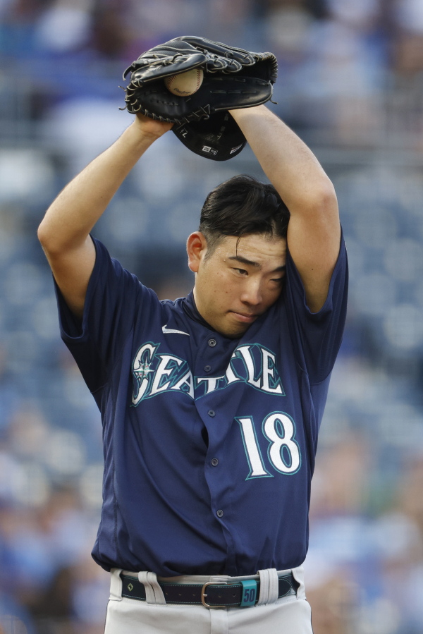Seattle Mariners pitcher Yusei Kikuchi wipes sweat from his brow during the first inning of a baseball game against the Kansas City Royals at Kauffman Stadium in Kansas City, Mo., Saturday, Sept. 18, 2021. (AP Photo/Colin E.