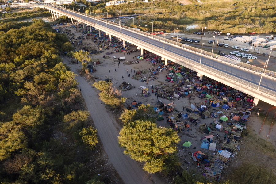 Migrants, many from Haiti, are seen in an encampment along the Del Rio International Bridge near the Rio Grande, Thursday, Sept. 23, 2021, in Del Rio, Texas.