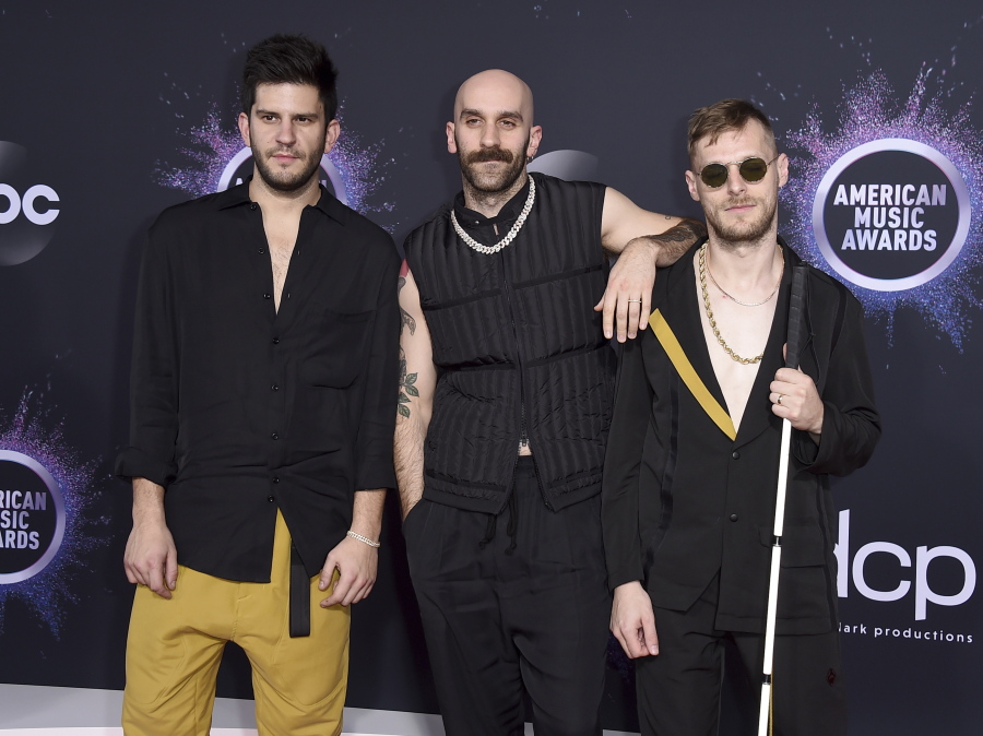 Adam Levin, from left, Sam Harris, and Casey Harris, of X Ambassadors, appear at the American Music Awards in Los Angeles on Nov. 24, 2019. The band's latest album "The Beautiful Liar," released Friday.