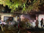 A house in the Orchards neighborhood caught fire early Saturday morning, and firefighters found a woman dead inside the house.