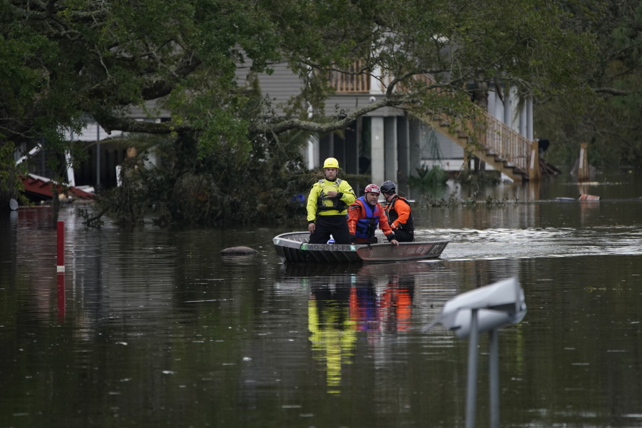 Animal rescue drive a boat down a flooded street in the aftermath of Hurricane Ida, Wednesday, Sept. 1, 2021, in Lafitte, La.  Following Hurricane Ida, mutual aid networks sprang into action to supplement the more established relief services from federal and local governments, and charities.