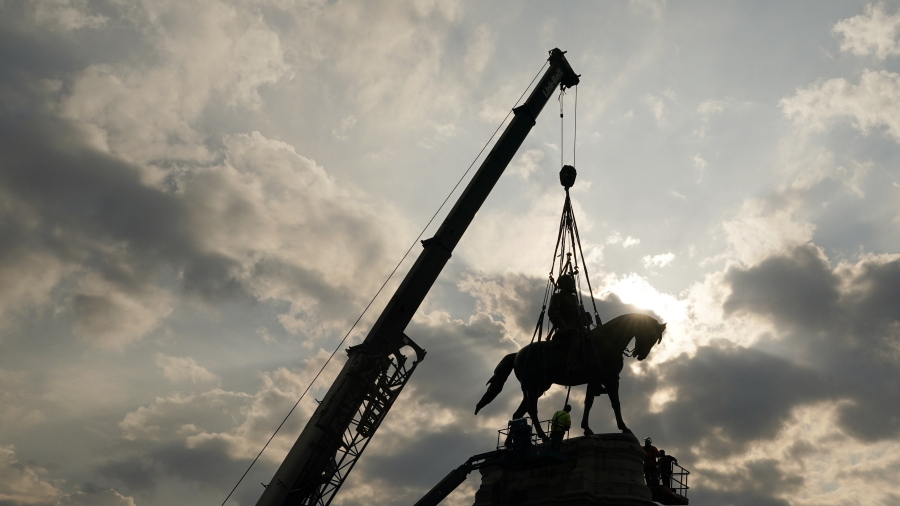 Crews work to remove one of the country's largest remaining monuments to the Confederacy, a towering statue of Confederate Gen. Robert E. Lee on Monument Avenue, Wednesday, Sept. 8, 2021, in Richmond, Va.