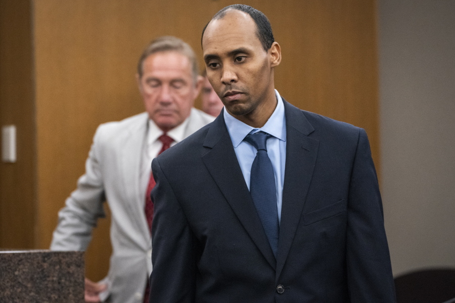 FILE - In this June 7, 2019 file photo, former Minneapolis police officer Mohamed Noor walks to the podium to be sentenced at Hennepin County District Court in Minneapolis. The Minnesota Supreme Court on Wednesday, Sept. 15, 2021, reversed the third-degree murder conviction of Noor who fatally shot an Australian woman in 2017, saying the charge doesn't fit the circumstances in this case.