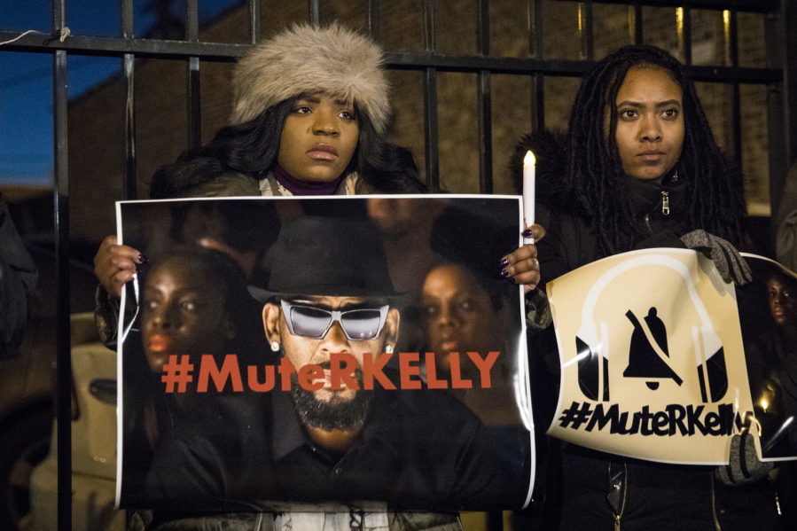 FILE - #MuteRKelly supporters protest outside R. Kelly's studio, Wednesday, Jan. 9, 2019, in Chicago. Accusers and others demanding accountability for the R&B superstar over allegations that he was abusing young women and girls for decades say it took so long to get to a guilty verdict in part because his targets were Black. Kelly was convicted Monday, Sept. 27, 2021, in his sex trafficking trial. Those who work against sexual violence say Black women and girls who want to speak out face a society that hypersexualizes them from a young age.
