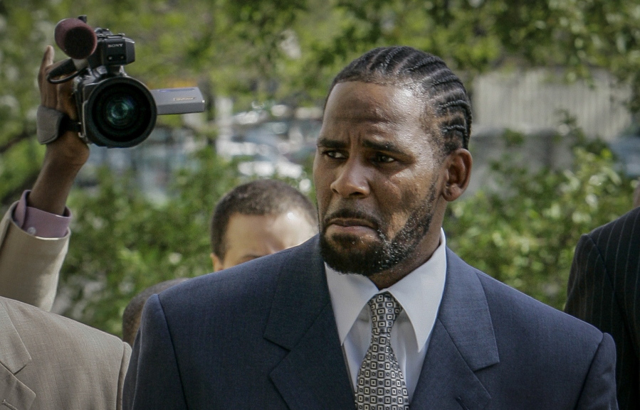 FILE - This photo from Friday May 9, 2008, shows R. Kelly arriving for the first day of jury selection in his child pornography trial at the Cook County Criminal Courthouse in Chicago. On Wednesday, Sept. 15, 2021, prosecutors in Kelly's sex trafficking trial at Brooklyn Federal Court in New York, played video and audio recordings for the jury they say back up allegations he abused women and girls.