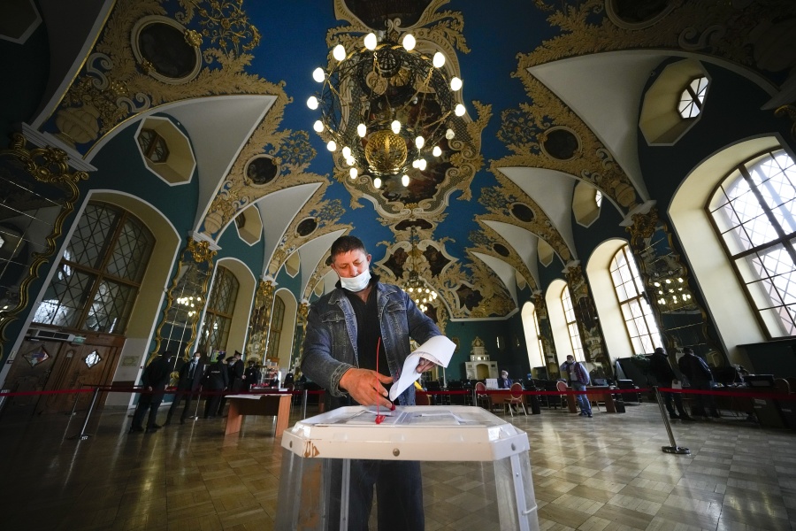 A man casts his ballot at a polling station at the Kazansky railway station during the Parliamentary elections in Moscow, Russia, Saturday, Sept. 18, 2021.  Sunday will be the last of three days voting for a new parliament, but there seems to be no expectation that United Russia, the party devoted to President Vladimir Putin, will lose its dominance in the State Duma.
