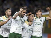 Portland Timbers forward Felipe Mora, second from right, and teammates celebrate his second-half goal against the Colorado Rapids during an MLS soccer match Wednesday, Sept. 15, 2021, in Portland, Ore.