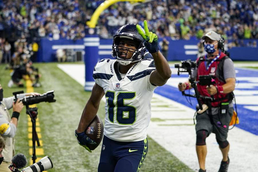 Seattle Seahawks wide receiver Tyler Lockett (16) celebrates after a touchdown against the Indianapolis Colts in the first half of an NFL football game in Indianapolis, Sunday, Sept. 12, 2021.