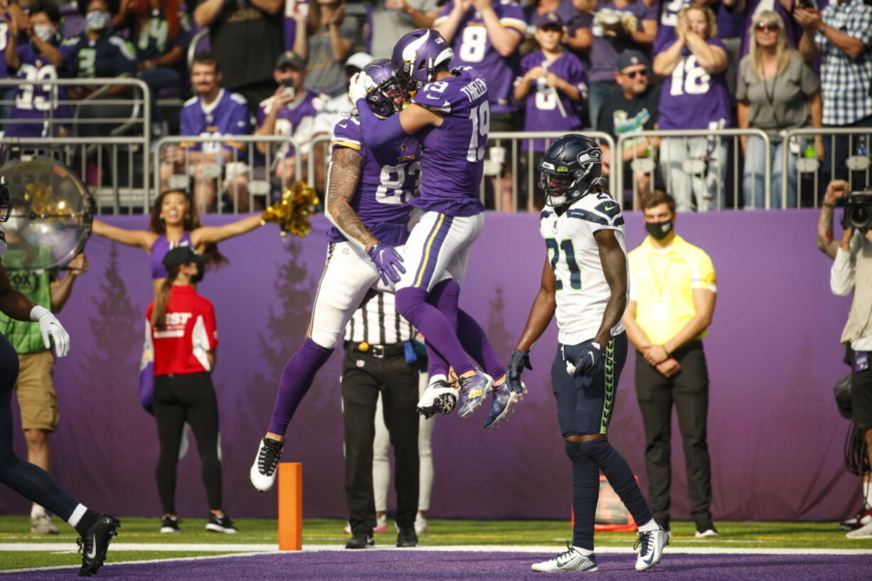 Minnesota Vikings tight end Tyler Conklin (83) celebrates with wide receiver Adam Thielen (19) after scoring a touchdown against the Seattle Seahawks in the first half of an NFL football game in Minneapolis, Sunday, Sept. 26, 2021.