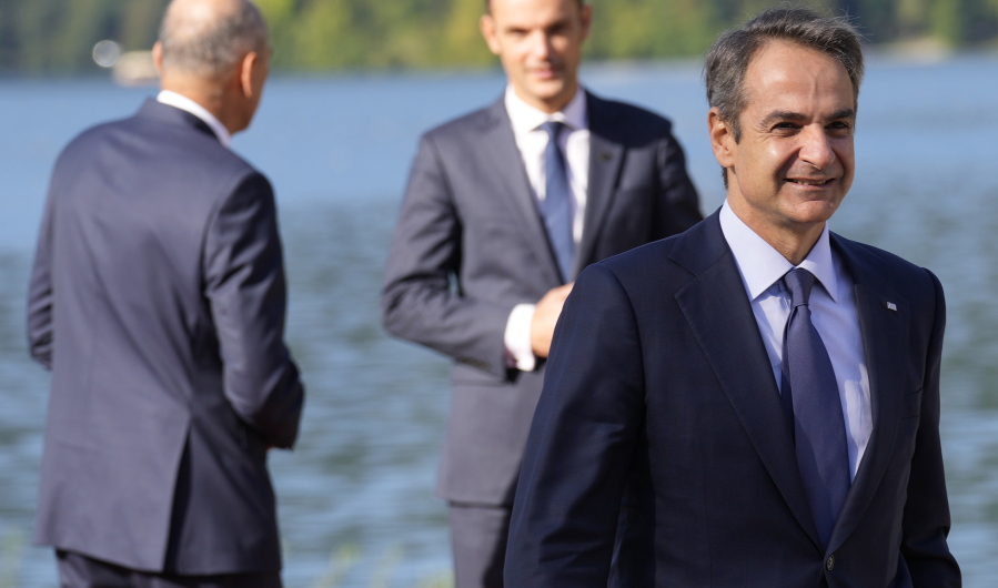 Greek Prime Minister Kyriakos Mitsotakis, right, arrives for a meeting of the Bled Strategic Forum at the Bled Festival Hall in Bled, Slovenia, Wednesday, Sept. 1, 2021. The Bled Strategic Forum gathers participants from various fields to discuss solutions to present and future challenges.