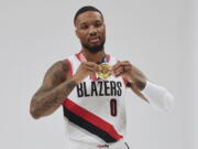 Damian Lillard poses with his Olympic gold medal during the Portland Trail Blazers' Media Day on Monday in Portland, Ore.