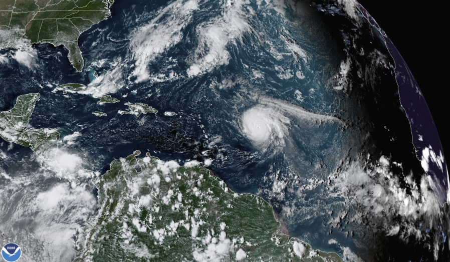 This satellite image provided by the National Oceanic and Atmospheric Administration shows Hurricane Sam, just right of center, in the Atlantic Ocean, Monday, Sept. 27, 2021, at 1920 Zulu (3:20 p.m. ET). Sam is a powerful Category 4 storm but it poses no threat to land as it loops northward in the Atlantic, according to the U.S. National Hurricane Center.