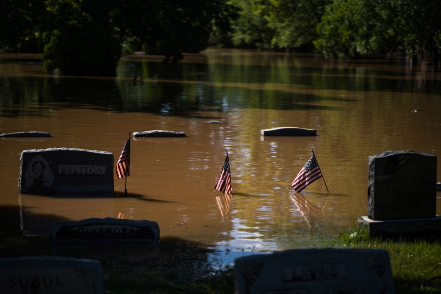 Headstones at a cemetery that flooded are seen in Somerville, N.J. Thursday, Sept. 2, 2021. A stunned U.S. East Coast faced a rising death toll, surging rivers, tornado damage and continuing calls for rescue Thursday after the remnants of Hurricane Ida walloped the region with record-breaking rain, drowning more than two dozen people in their homes and cars.