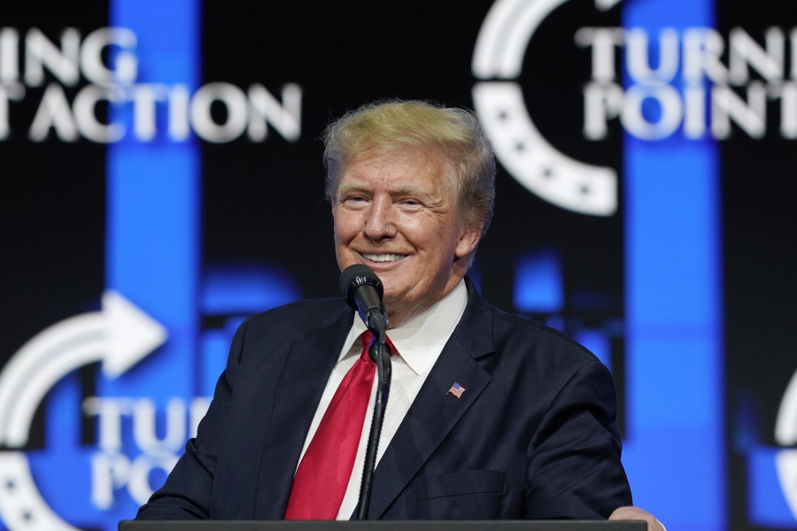 FILE - In this July 24, 2021, file photo former President Donald Trump smiles as he pauses while speaking to supporters at a Turning Point Action gathering in Phoenix. As he mulls a comeback run for president in 2024, former President Donald Trump has been wading into local secretary of state and attorney general races in key swing states. (AP Photo/Ross D.
