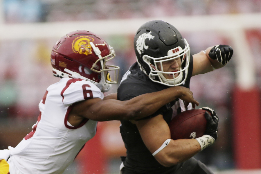 Washington State running back Max Borghi, right, carries the ball while pressured by Southern California cornerback Isaac Taylor-Stuart during the first half of an NCAA college football game, Saturday, Sept. 18, 2021, in Pullman, Wash.