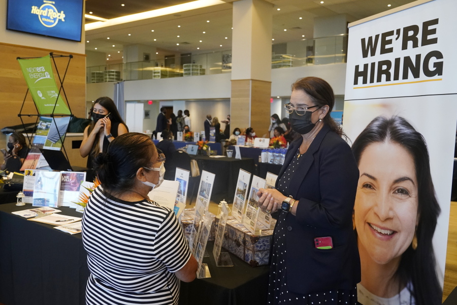 Marriott human resources recruiter Mariela Cuevas, left, talks to Lisbet Oliveros, during a job fair at Hard Rock Stadium, Friday, Sept. 3, 2021, in Miami Gardens, Fla.  The number of Americans seeking unemployment benefits fell sharply last week to 310,000, a pandemic low and a sign that the surge in COVID-19 cases caused by the delta variant has yet to lead to widespread layoffs.