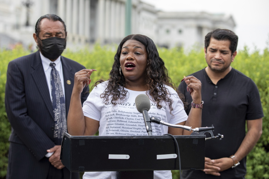 FILE - In this Aug. 3, 2021, file photo Rep. Cori Bush, D-Mo., flanked by Rep. Al Green, D-Texas, left, and Rep. Jimmy Gomez, D-Calif., right, speaks to the press after it was announced that the Biden administration will enact a targeted nationwide eviction moratorium outside of Capitol Hill in Washington. Several progressive lawmakers, including Bush, on Tuesday, Sept. 21, introduced a bill that would reimpose a nationwide eviction moratorium at a time when deaths from COVID-19 are running at their highest levels since early March.