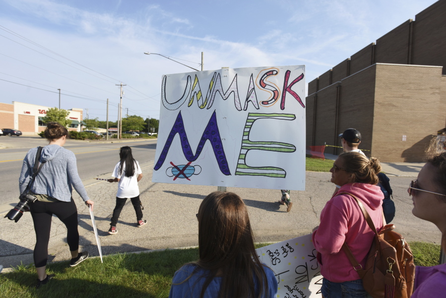 Protesters gather in front of Lakeshore High School, in Stevensville, Mich., Tuesday. Sept. 7, 2021, to protest recent COVID-19 mask mandates.