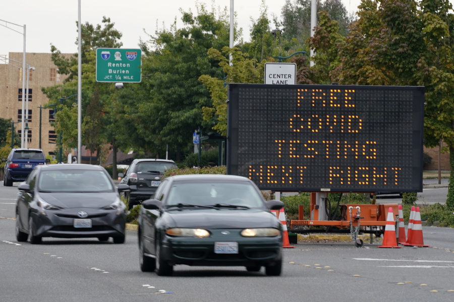 A sign directs motorists to a COVID-19 testing site, Wednesday, Sept. 22, 2021, in Tukwila, Wash., south of Seattle. (AP Photo/Ted S.