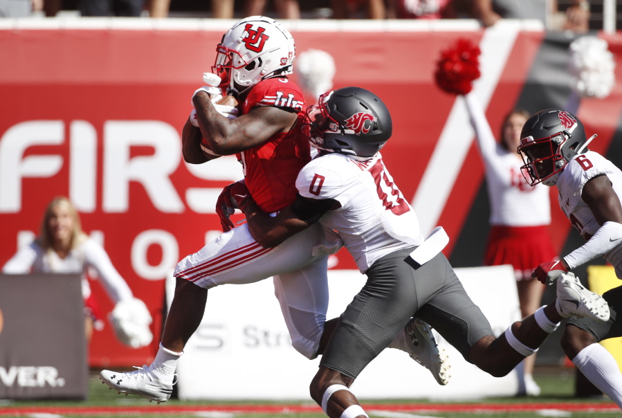 Utah running back TJ Pledger (5) runs for a touchdown as Washington State defensive back Jaylen Watson (0) tries to tackle him in the second half, of an NCAA college football game Saturday, Sept. 25, 2021, in Salt Lake City.