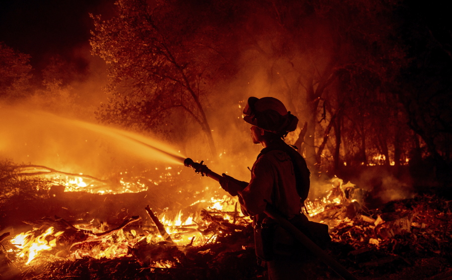 Firefighter Ron Burias battles the Fawn Fire as it spreads north of Redding, Calif. in Shasta County, on Thursday, Sept. 23, 2021.