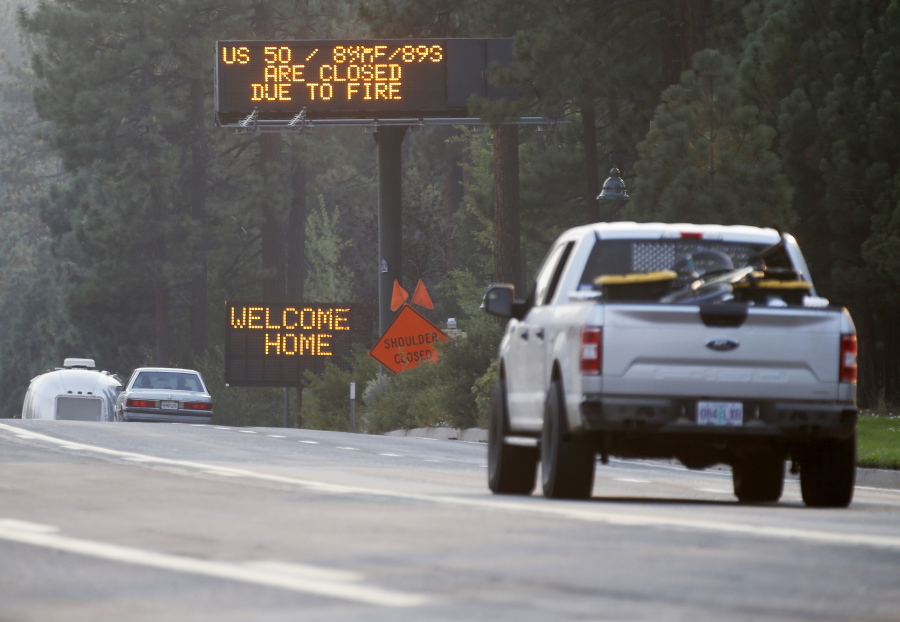 Traffic flows along Highway 50 in South Lake Tahoe, Calif., Sunday, Sept. 5, 2021. Cal Fire officials downgraded some evacuation orders near Lake Tahoe and allowed thousands of South Lake Tahoe residents who fled the Caldor Fire last week to return home Sunday.