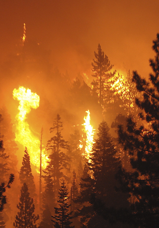 Bursts of energy go up in balls of fire after the Caldor Fire moved into the Christmas Valley and began making its way along the the South Tahoe rim towards Heavenly, Monday, Aug. 30, 2021 in South Lake Tahoe, Calif .