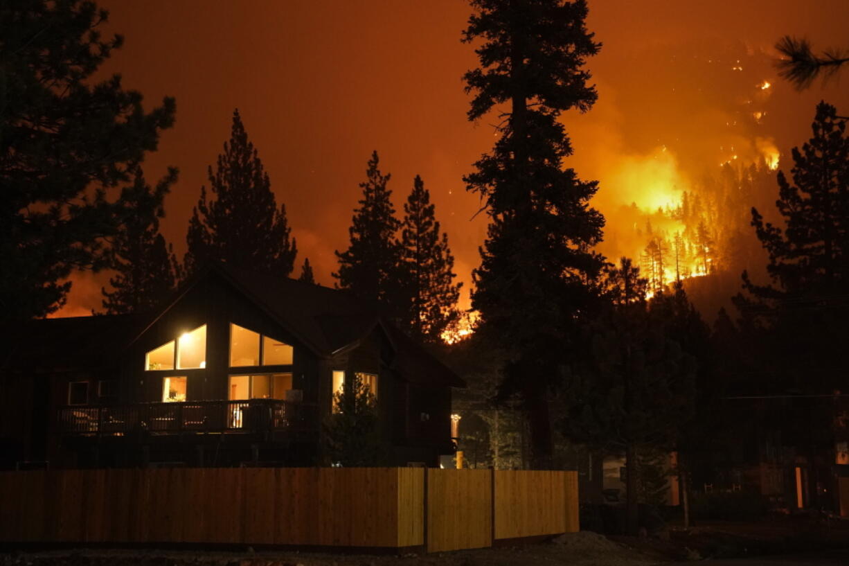 The Caldor Fire burns near homes near South Lake Tahoe, Calif., Wednesday, Sept. 1, 2021. (AP Photo/Jae C.