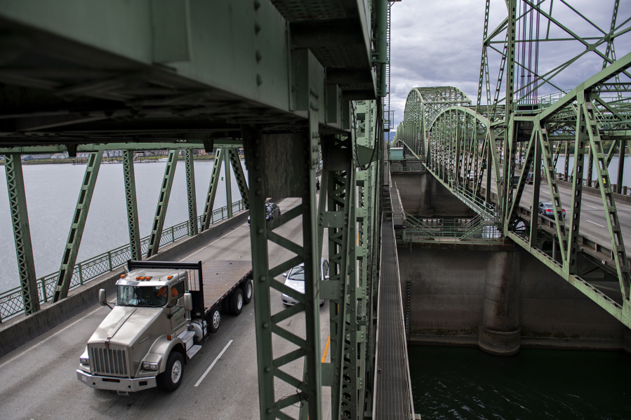A truck driver travels north on the Interstate Bridge.