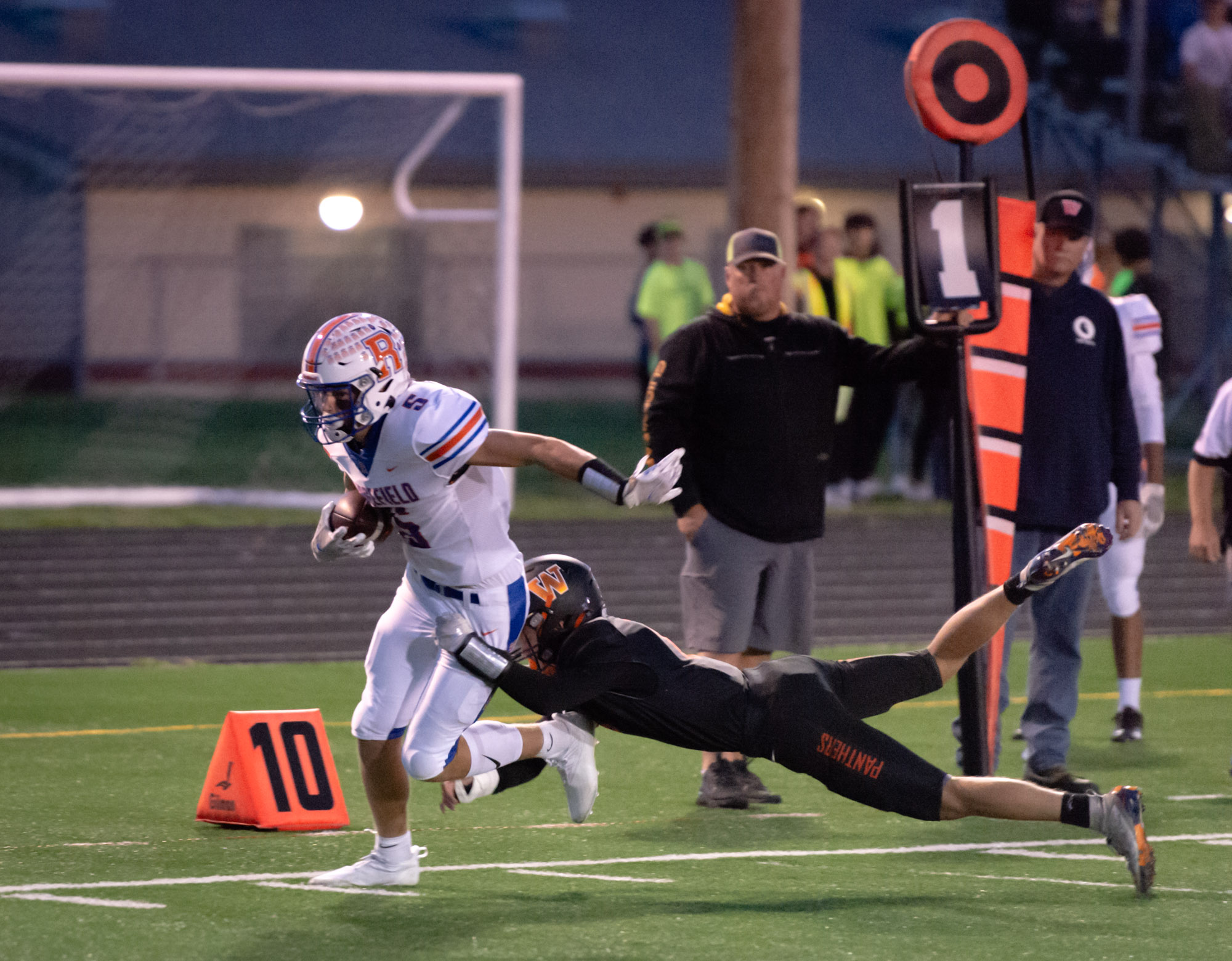 Ridgefield's Ty Snider tries to muscle his way to the end zone but Washougal's Matt Brown drags him down  in a 2A Greater St. Helens League football game on Friday, Oct. 1, 2021, at Fishback Stadium in Washougal. Ridgefield won 39-13.