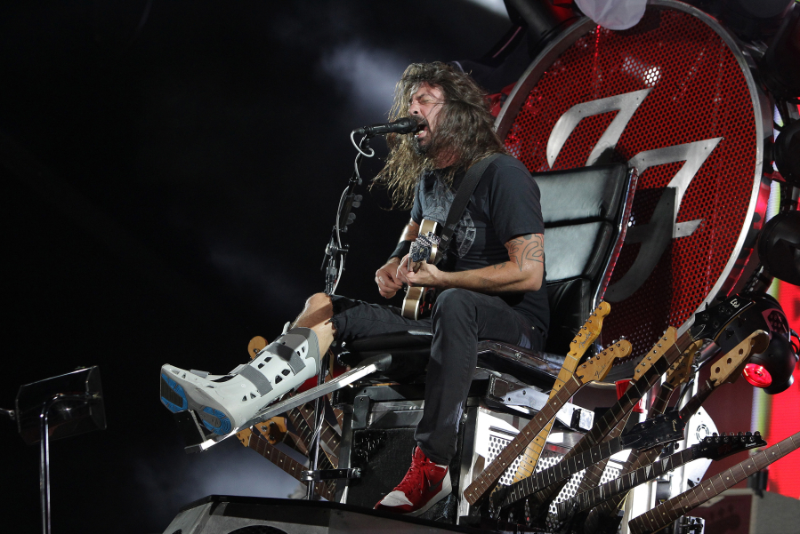 Dave Grohl of the Foo Fighters performs on stage in a throne due to a broken leg during the Ansan Valley Rock Festival on July 26, 2015, in Ansan, South Korea.