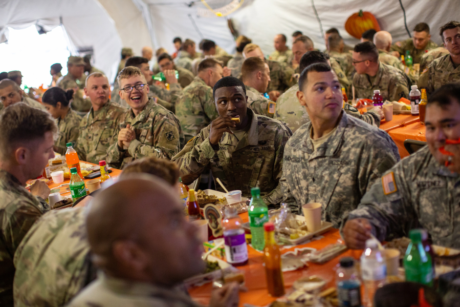 U.S. Army troops deployed to the U.S.-Mexico border eat a Thanksgiving meal at a base near the Donna-Rio Bravo International Bridge on November 22, 2018, in Donna, Texas.