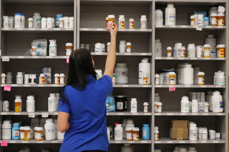 A pharmacy technician grabs a bottle of drugs off a shelve at the central pharmacy of Intermountain Heathcare on Sept. 10, 2018 in Midvale, Utah.