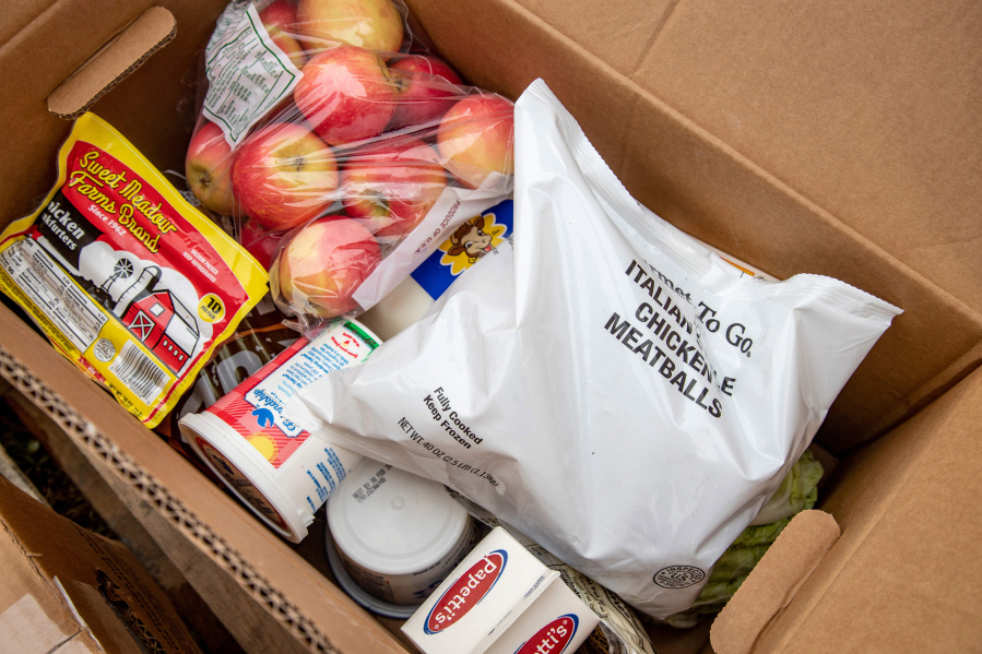 Contents of a USDA Farmers to Families food box includes apples, meatballs, hotdogs, milk and other fresh items that need to be consumed in a timely manner, in Athens, Ohio, on December 19, 2020.