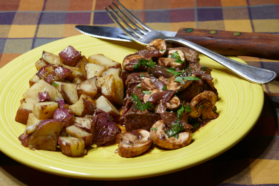 Steak in red wine sauce with garlic potatoes.