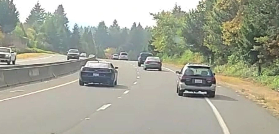 The Clark County Sheriff's Office is looking for information about the driver of the green Subaru Outback who police believe fired shots at the black Camaro, pictured Sept. 22.