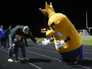 A young fan meets the Ridgefield Spudders team mascot during a 2A Greater St. Helens League football game at Ridgefield High School on Thursday, Oct. 7, 2021.