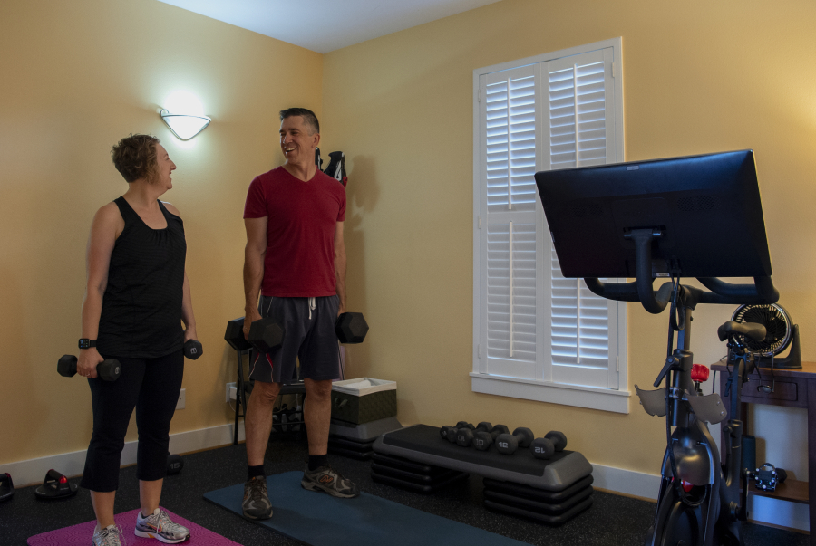 Amy Hawkins and Ben Novinger begin a workout at their home in Portland. They are participants in a OHSU's Knight Cancer Institute trial program called Exercising Together. Continuing research demonstrates that exercise is beneficial during and after cancer treatment.