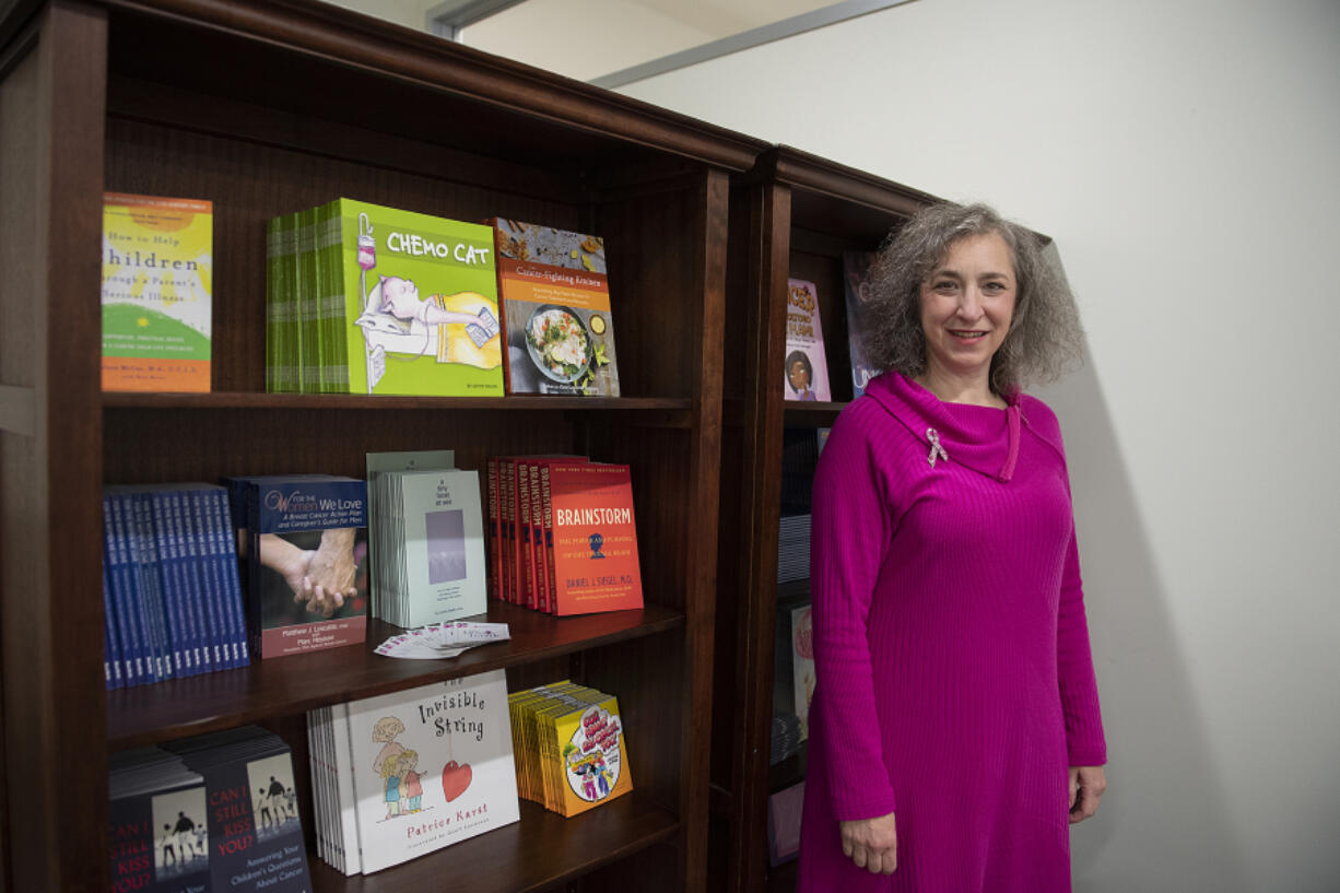 Susan Stearns stands near the book bank at Pink Lemonade Project's downtown Vancouver offices. She took over as CEO of the nonprofit as the pandemic hit in March 2020 and has guided an expansion of programs. Participation increased 30 percent during the pandemic.
