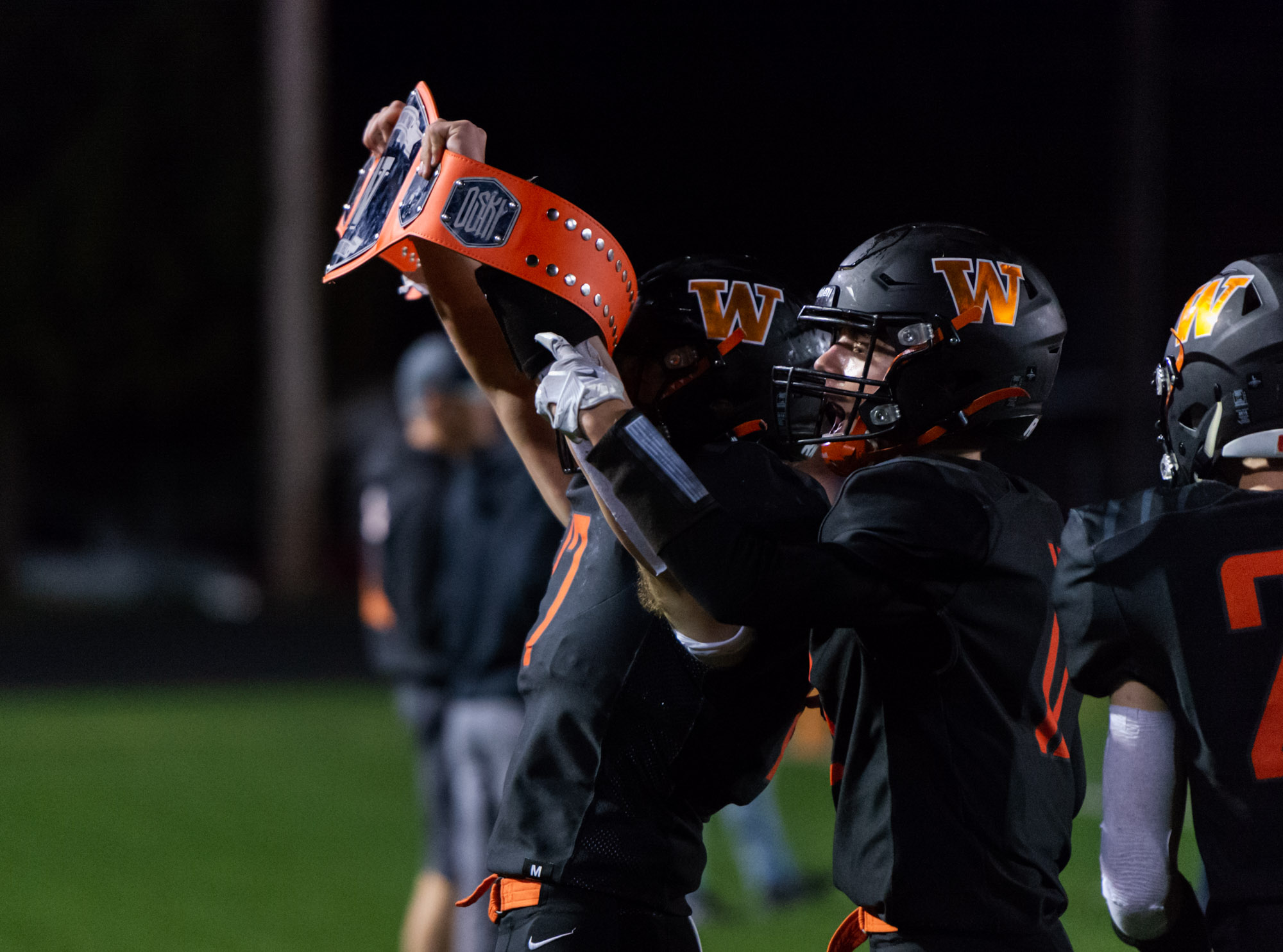 Washougal's Garrett Mansfield lifts the turnover belt after recovering a fumble in a 2A Greater St. Helens League football game on Friday, Oct. 1, 2021, at Fishback Stadium in Washougal. Ridgefield won 39-13.