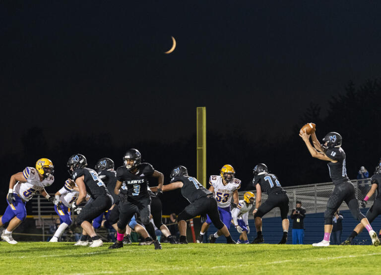 A waxing crescent moon hangs above the Hockinson High School football field Friday, Oct. 8, 2021, during the Hawks’ 31-6 win against Columbia River.