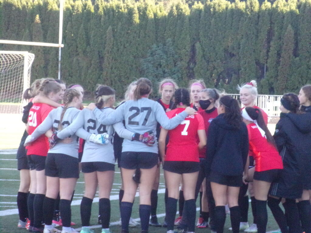 The Camas girls soccer team huddle up before its 4A bi-district playoff against Curtis on Saturday, Oct.
