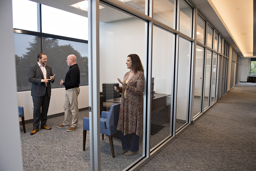 Al Angelo Co. President Albert Angelo III, left, chats with Scott Wilcox and Bari Smith of JD Fulwiler & Co. Insurance in the commercial side of Vancouver's newest building, the Angelo Tower.
