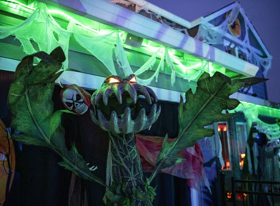 An animatronic plant monster waves its arms at Jim and Cecilia Mains' house on Franklin Street in Vancouver.