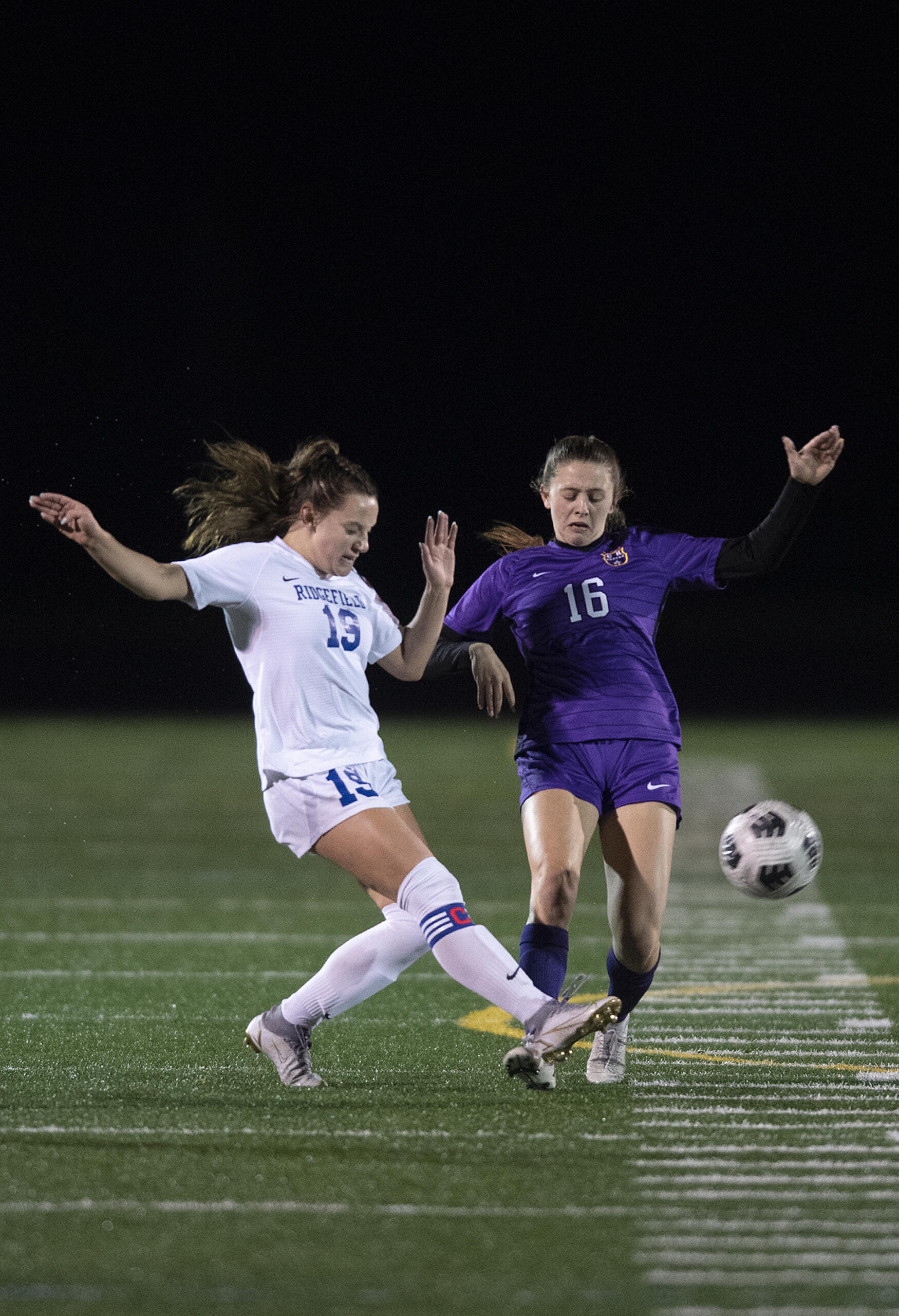 Ridgefield's Paytn Barnette (19) and Columbia River's Kinzi Drake (16) battle for the ball in the first half at Columbia River High School on Tuesday night, Oct. 12, 2021.