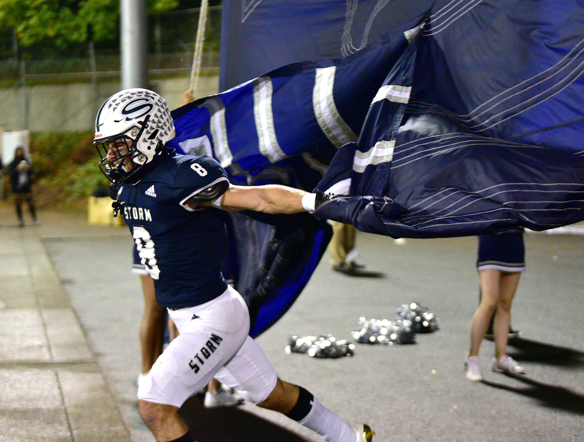 Skyview senior Jaydin Knapp bursts through a banner Thursday, Oct. 14, 2021, at the start of the game between Union and Skyview at the Kiggins Bowl in Vancouver.