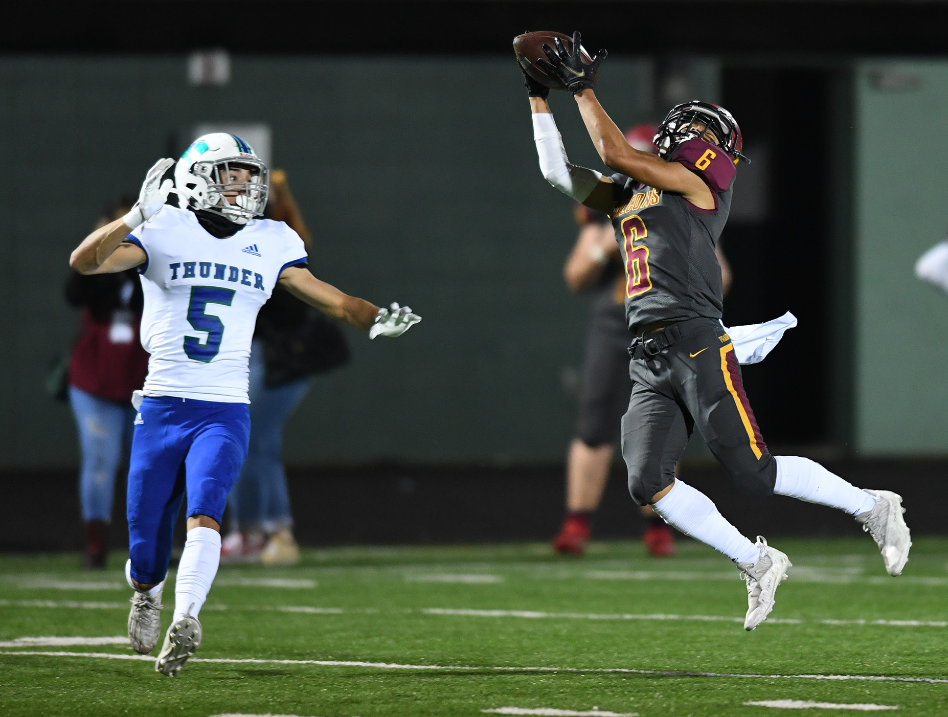 Prairie junior Nathan Phingphouvagh, right, makes a leaping catch under pressure from Mountain View sophomore Jacob Martin on Friday, Oct. 15, 2021, during the Falcons’  17-14 loss to Mountain View at Battle Ground High School.