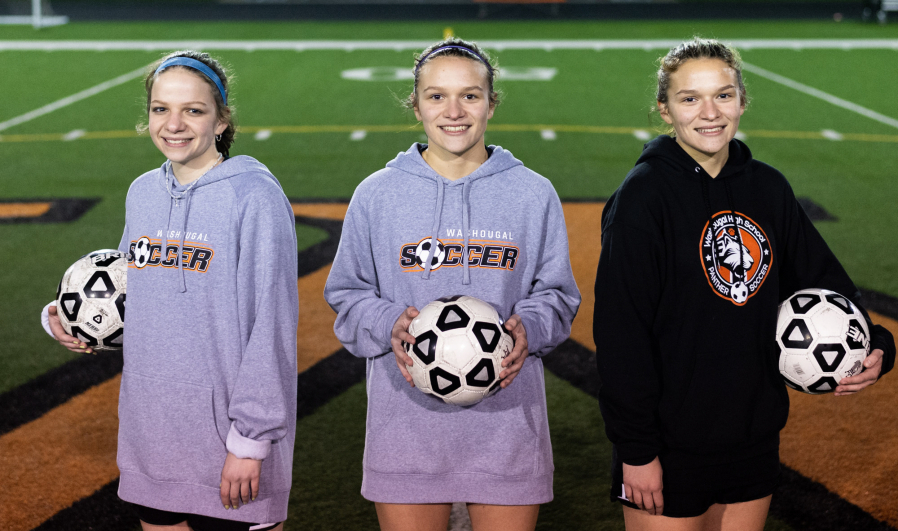 From left, Molly, Emily and Lauren Rabus pose for a portrait after a practice on Monday, Oct. 18, 2021, at Washougal High School.