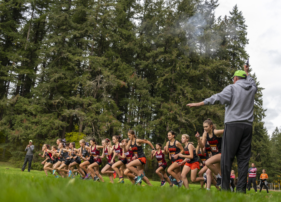 Varsity girl???s cross country runners begin their race Wednesday, Oct. 20, 2021, during the 4A Greater St. Helens League Cross Country District Meet at Lewisville Regional Park in Battle Ground.