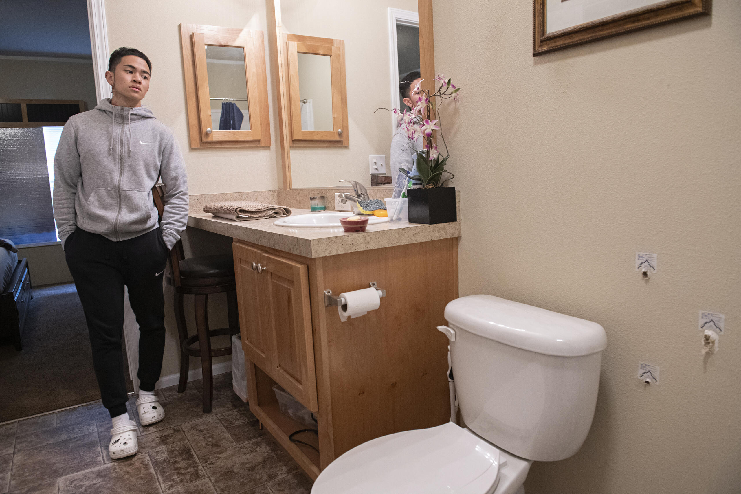 Lorenz Soriano of Vancouver looks over three bullet holes, right, in his bathroom Monday afternoon, Oct. 18, 2021, after Clark County sheriffs deputies fired at a suspect the agency said was armed with a handgun early Sunday morning.